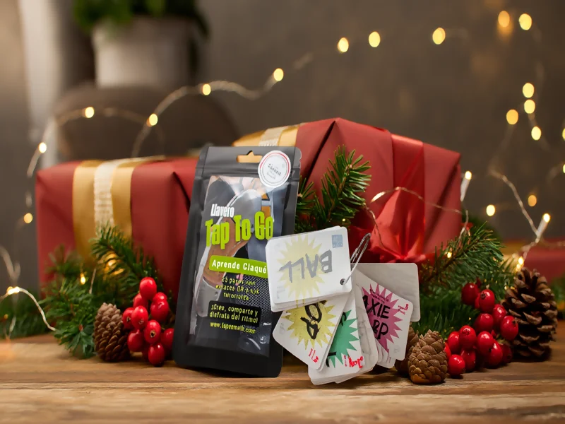 Niños bailando con TAP TO GO y árbol de Navidad al fondo